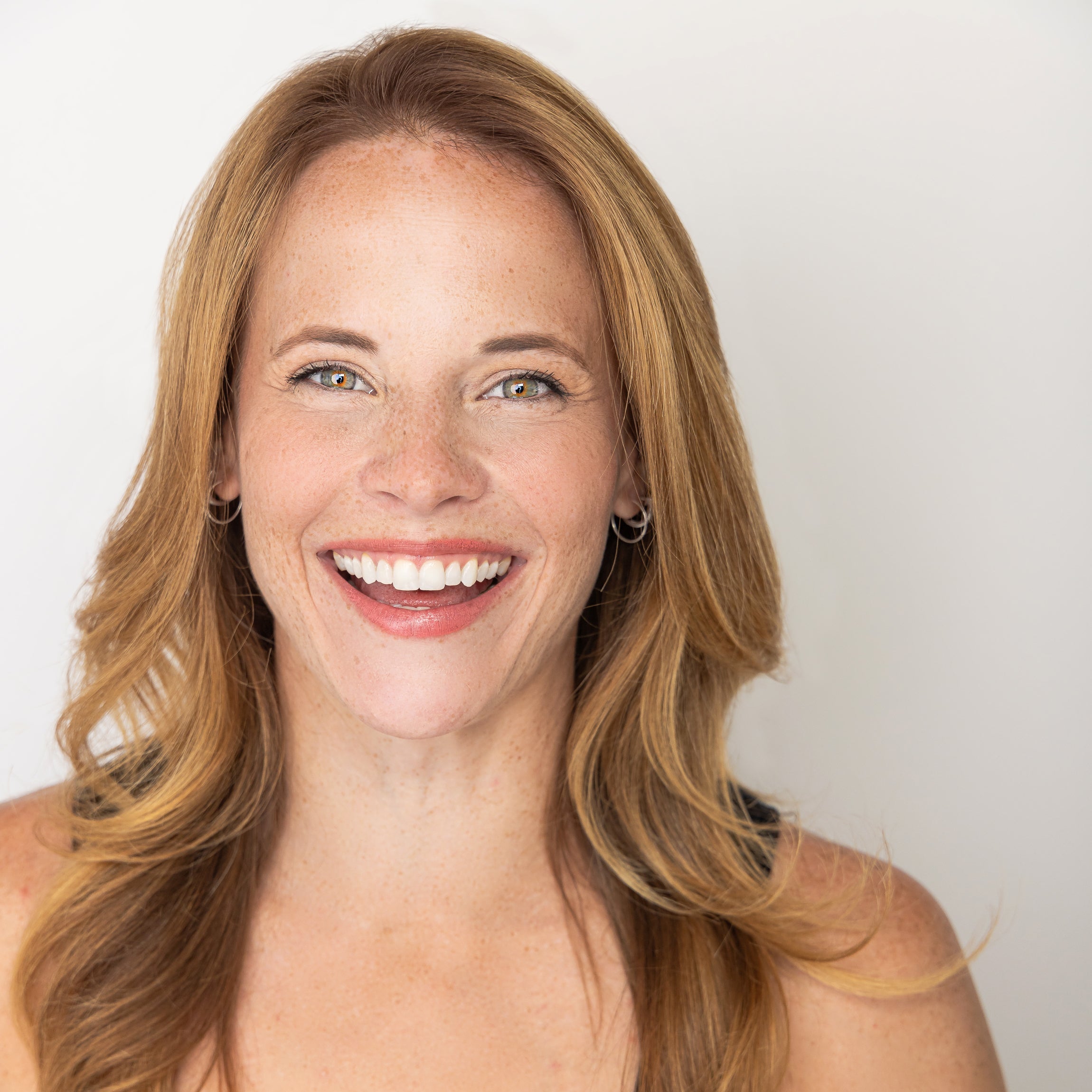 Photo of actress and producer Katie Leclerc smiling at the camera